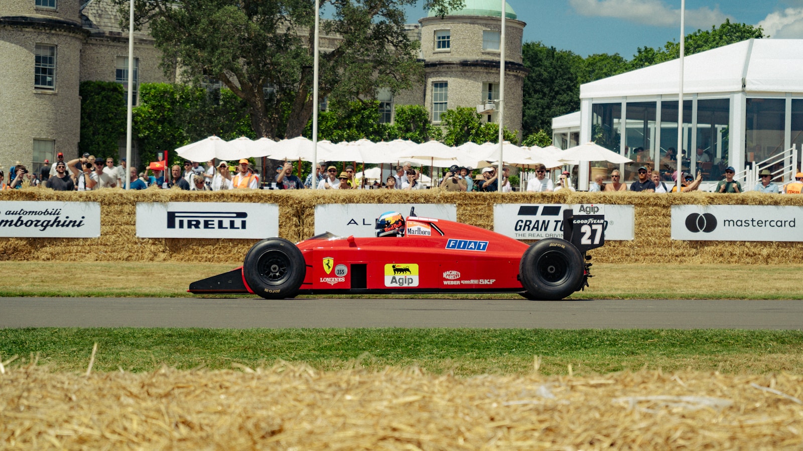 Red vintage formula 1 car racing on track